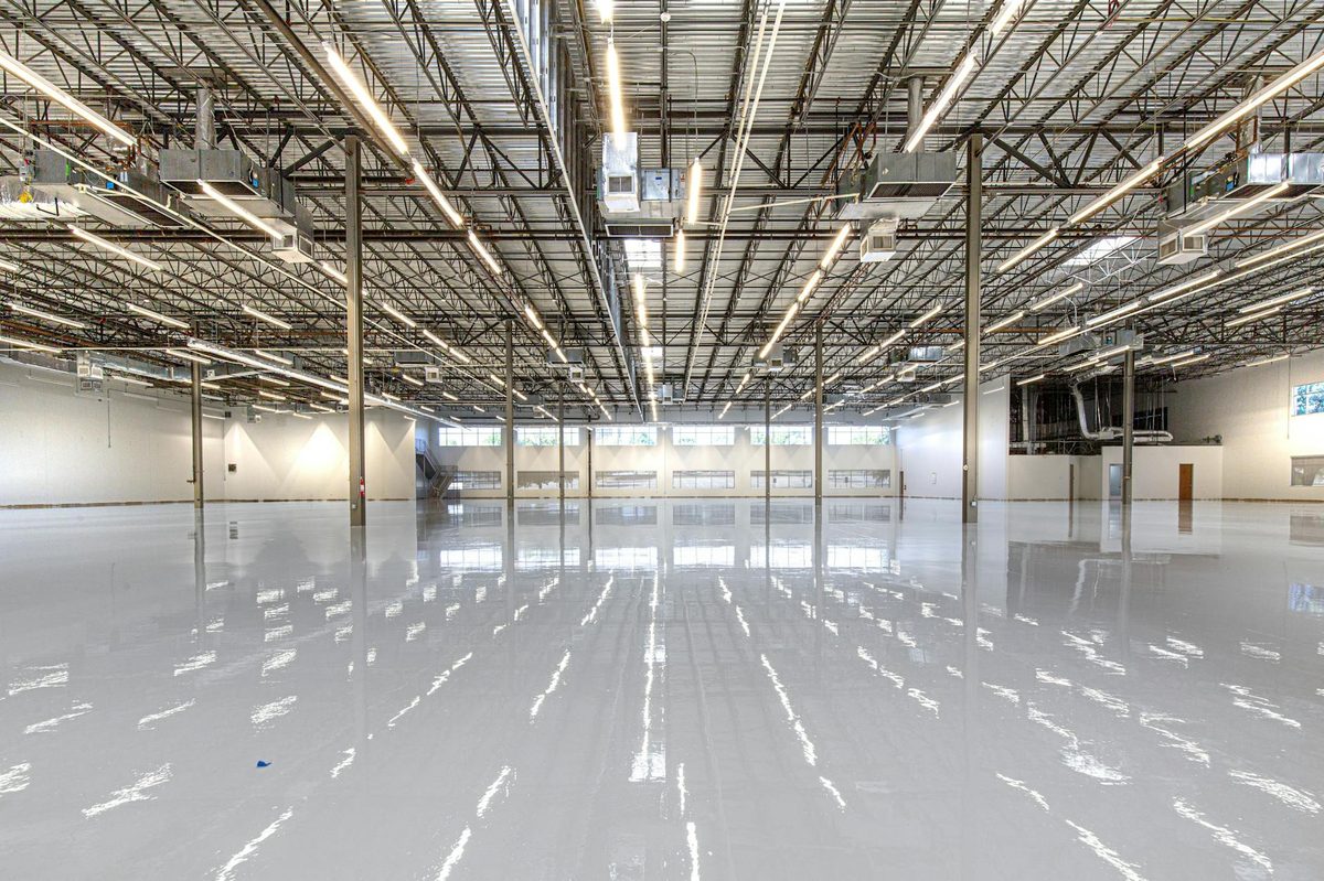 Glossy epoxy floor coating in a large industrial interior